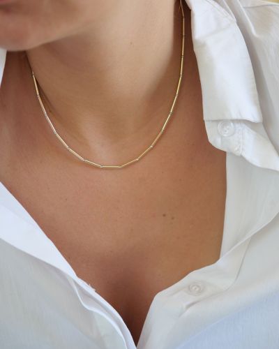 Collier Alba 19 Collier Nova en tubes d’or laminé et perles en argent 925 porté avec une chemise blanche